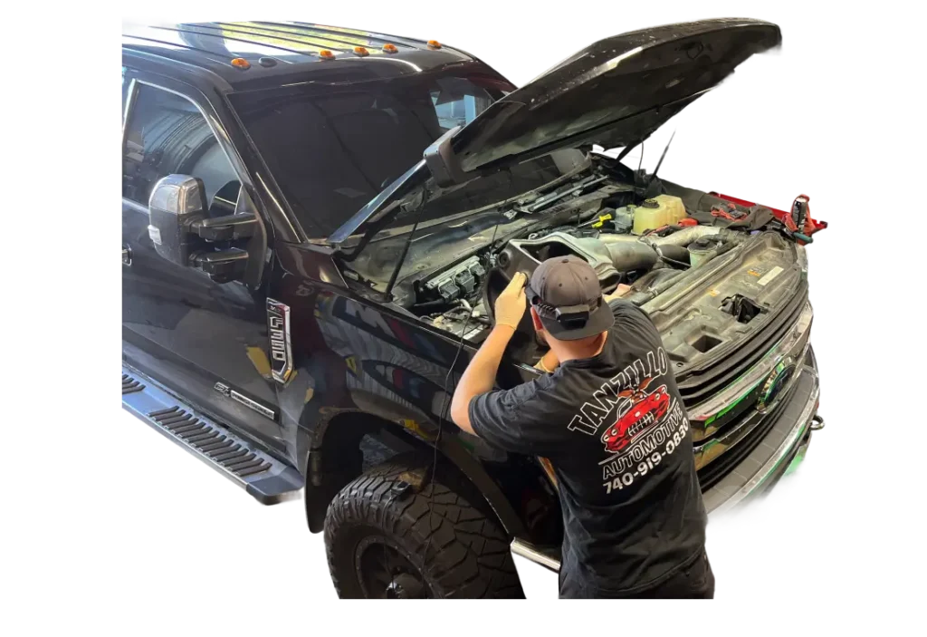 Mechanic working on black truck engine