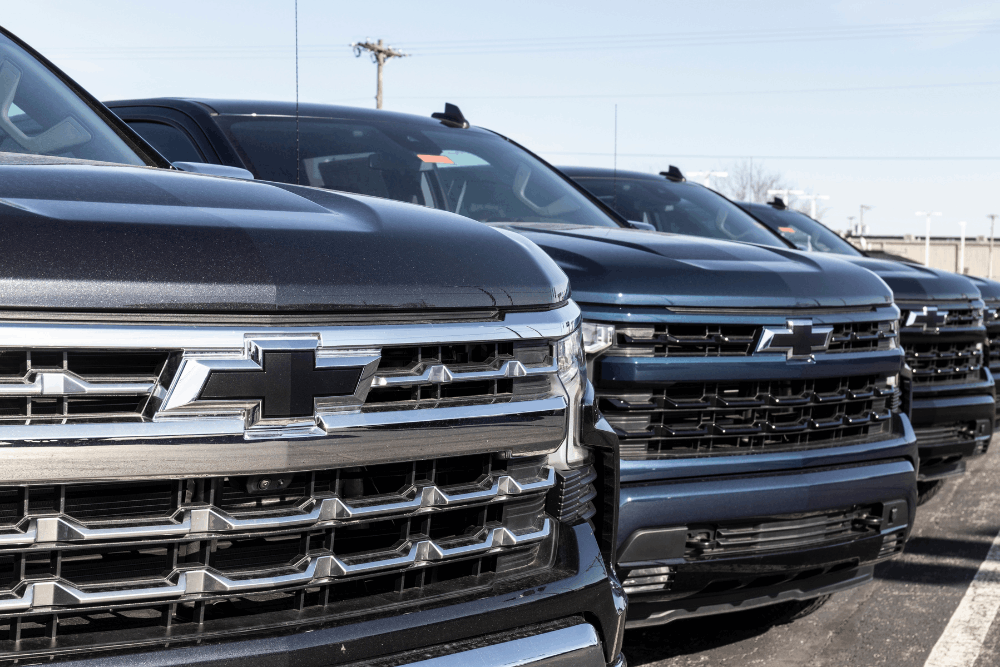 DOD lifter, auto repair in Pataskala, OH by Tanzillo Automotive. Image of multiple Chevrolet Silverado trucks lined up in a parking lot, highlighting dependable service for work trucks and daily drivers.