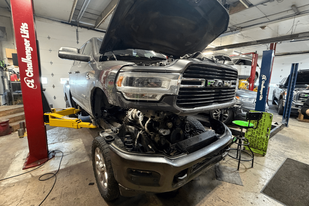 Diesel Hot Start Diagnosis, Diesel Repair in Pataskala, OH at Tanzillo Automotive. RAM diesel truck with hood open on a lift for engine diagnosis in Pataskala, OH